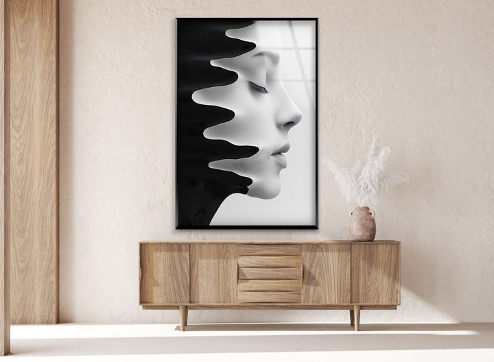 Abstract portrait with flowing black paint on a glass canvas.
