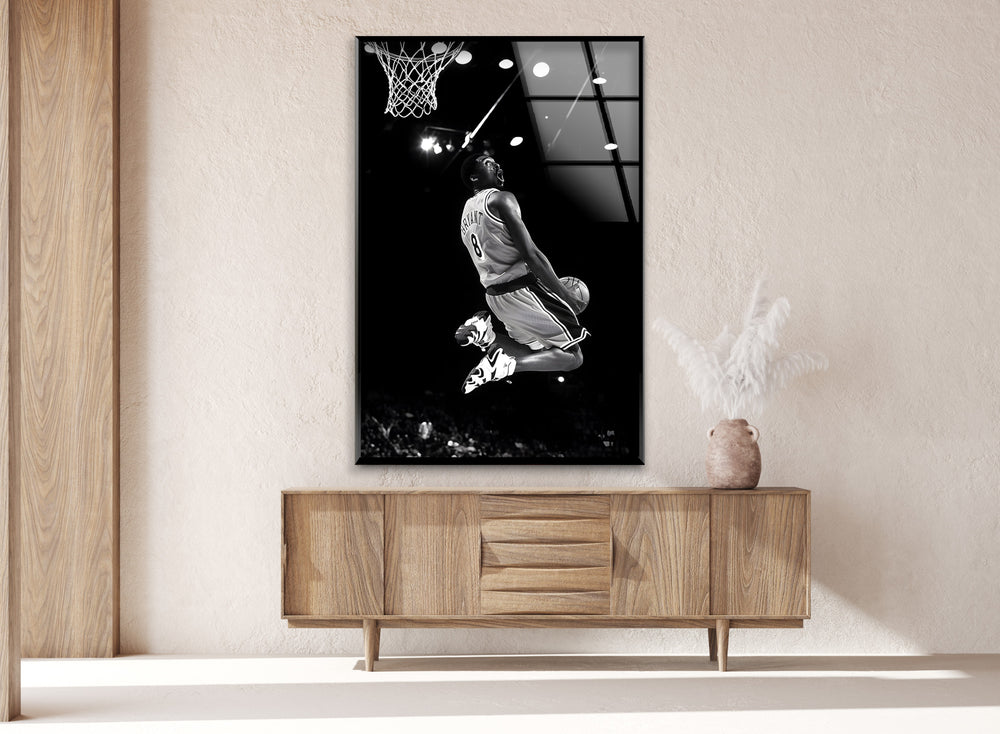 Relive the excitement of Kobe's legendary dunk with this powerful black and white glass wall art.

