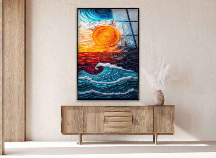 Glass wall art displaying bold, fluid wave patterns in rich blues and fiery oranges.
