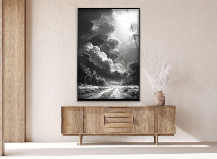 Large glass wall decor highlighting a dark sky and a glowing break in the clouds.
