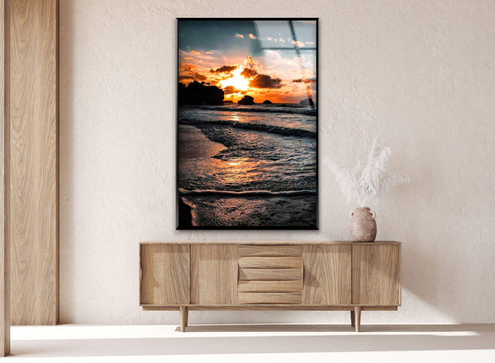 Golden sunset casting beautiful reflections on the ocean, creating a serene atmosphere.
