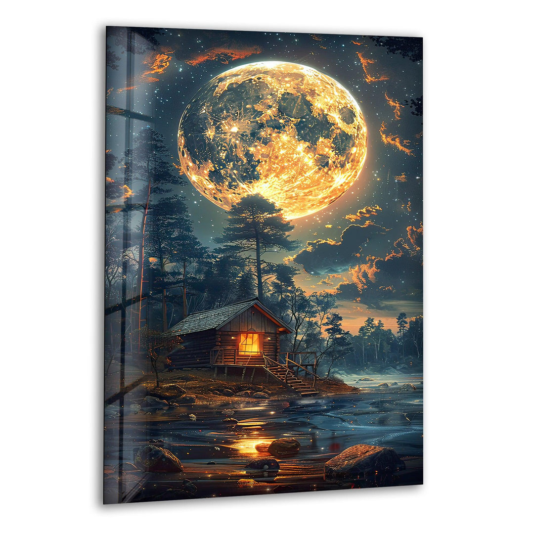 Glass wall art featuring a glowing full moon over a cozy forest cabin.
