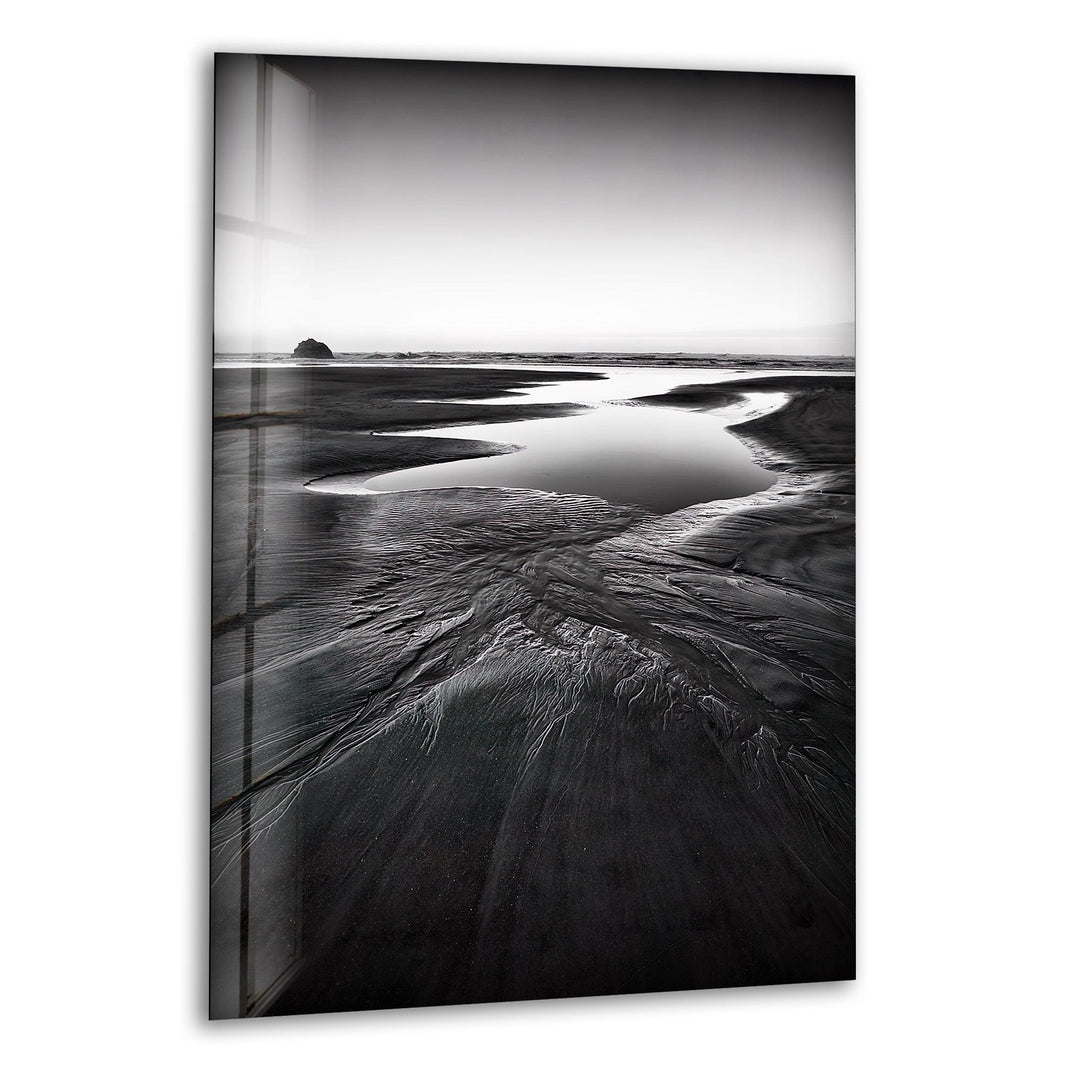 A breathtaking glass wall art featuring a monochrome beach landscape with serene coastal elements.
