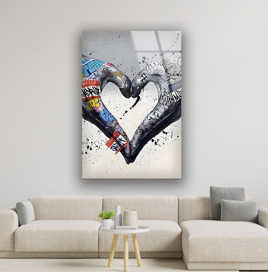 An abstract heart of graffiti-covered hands forms cool decorative wall art on a reflective surface.