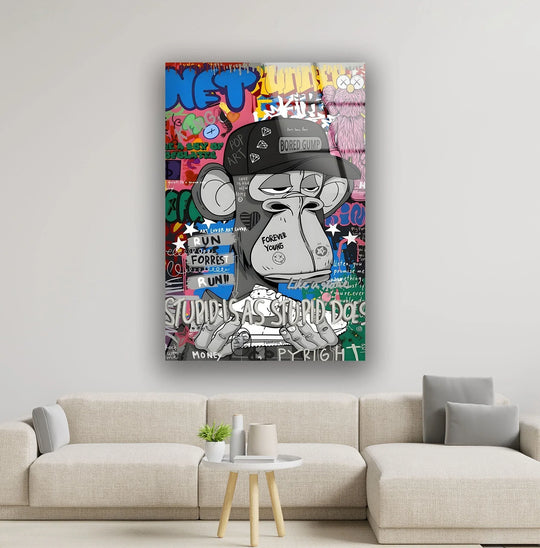 A detailed pop art monkey face glass wall art with graffiti-inspired elements and a pink cartoon character.