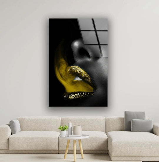 Dramatic light and shadow highlight the striking contrast of a black woman's face with shimmering gold lips in this alluring print wall art.
