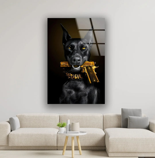 A striking black doberman with bright yellow eyes holds a gleaming golden gun, featured on bold animal glass printing.