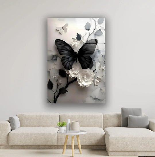 A black butterfly and white flowers evoke stillness in this elegant glass art painting.