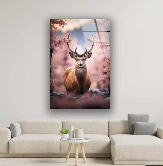 A majestic deer with elaborate antlers stands amidst a symphony of soft pink blossoms, creating a gentle visual rhythm on this wall art print.