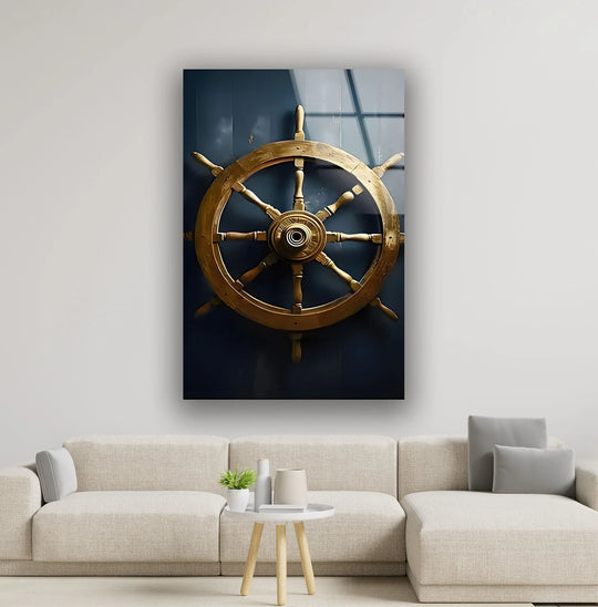 A vintage golden ship's wheel hangs in still silence, a timeless piece of home decoration against a deep navy wall.
