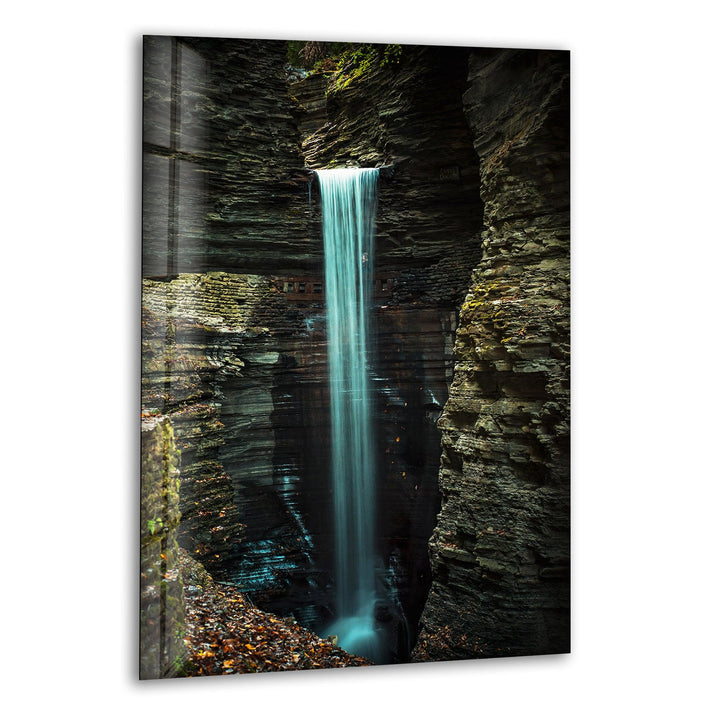 Breathtaking waterfall cascading through a rugged rock gorge, captured in high-definition glass wall art.
