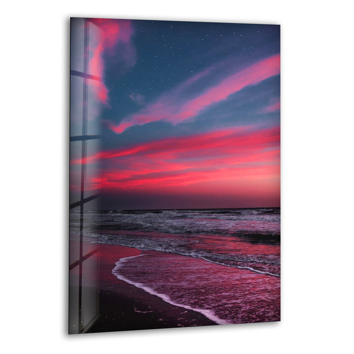 Dramatic crimson and purple sunset over ocean waves, printed on glass wall art.
