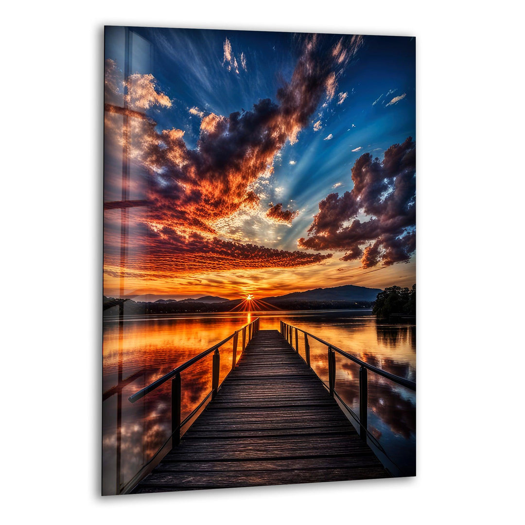 Glass wall art featuring a breathtaking sunset over a tranquil lake.
