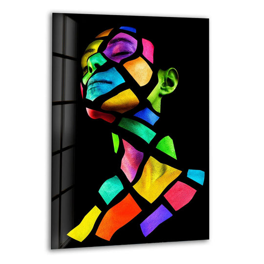 This striking glass art showcases a human face fragmented into vibrant, contrasting color blocks against a deep black background.