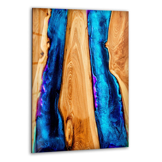Vibrant blue epoxy rivers flow through natural wood grain on this stunning wall prints glass art.