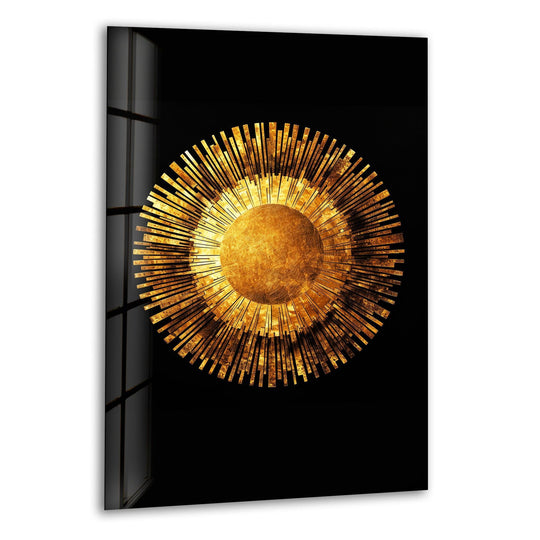 A circular gold sunburst on black background art on glass, radiating outward with geometric sun rays.