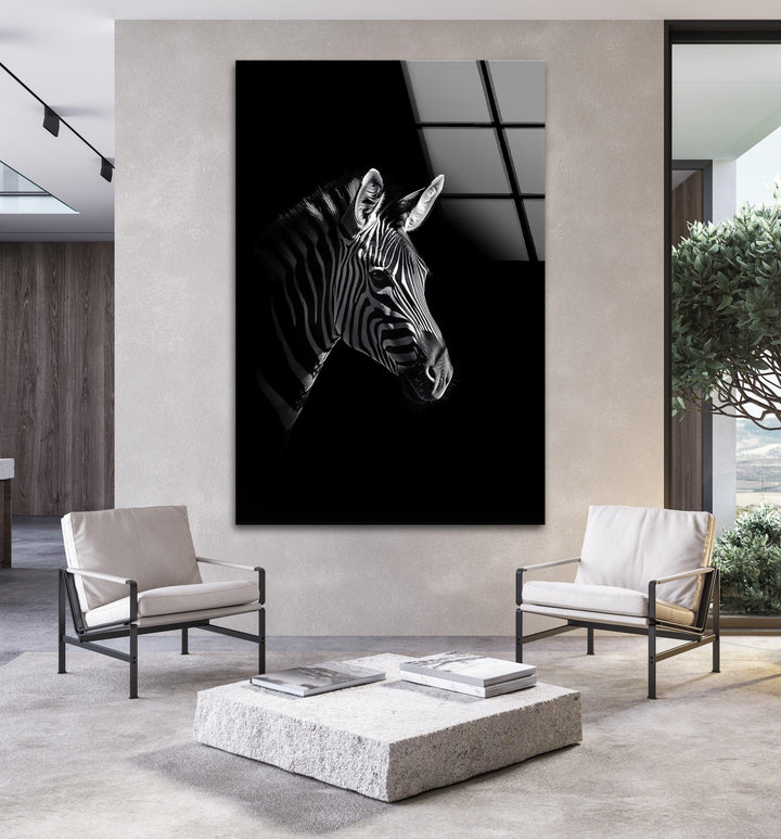 Minimalist glass wall art of a zebra head highlighted against pure black space.