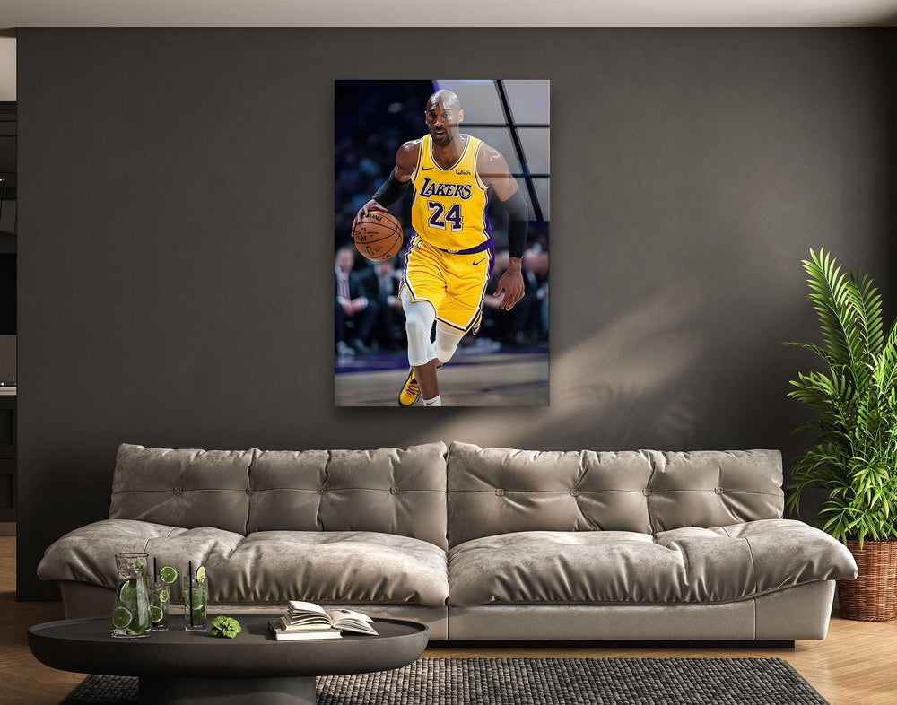 Kobe Bryant Glass wall art of a professional basketball player in a yellow uniform dribbling down the court.