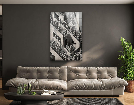 Vertical glass wall art prints depict surreal Escher-inspired people navigating abstract geometric staircases.