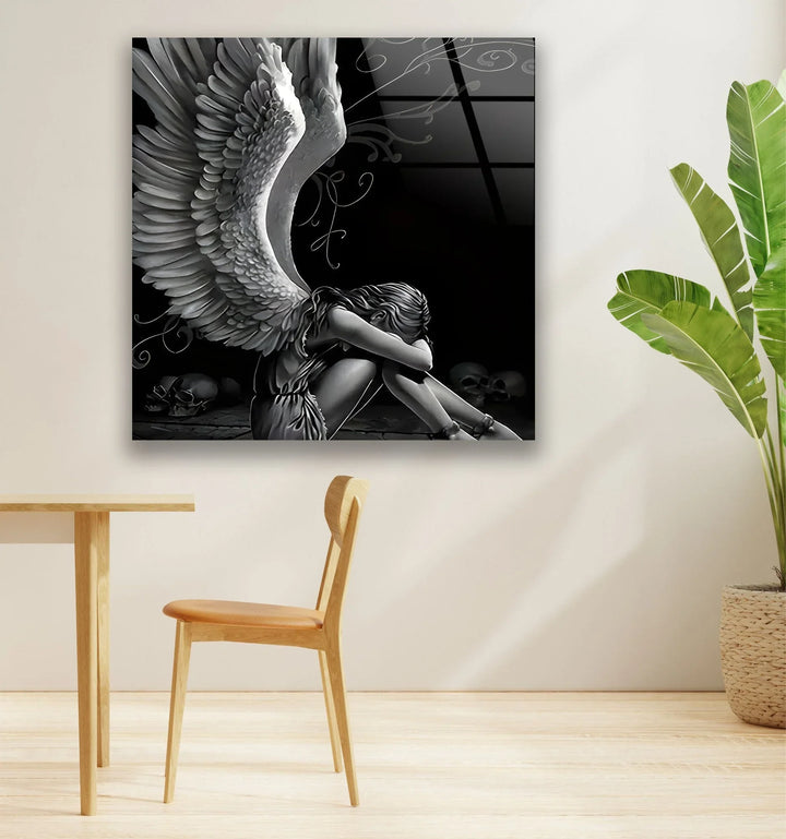 Dark abstract angel artwork on glass with intricate wing textures and a sorrowful seated figure.