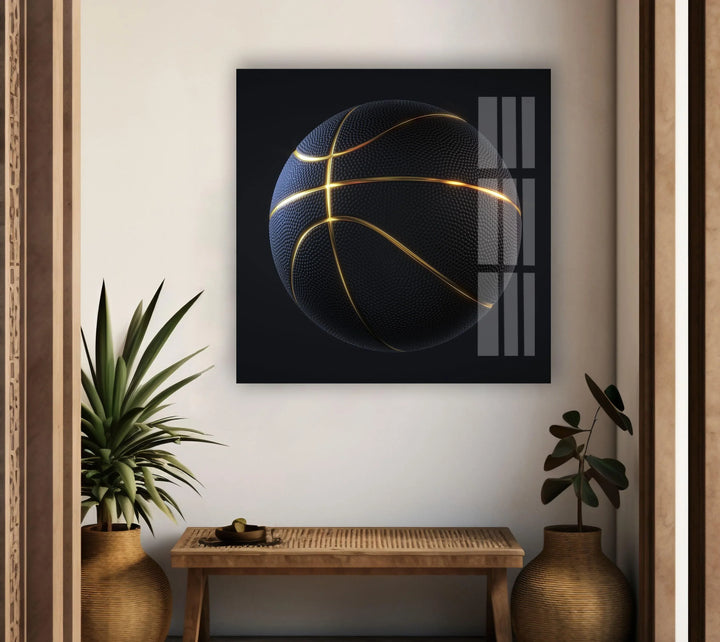 Stylish glass wall art of a basketball with bright gold accents against a deep black backdrop.