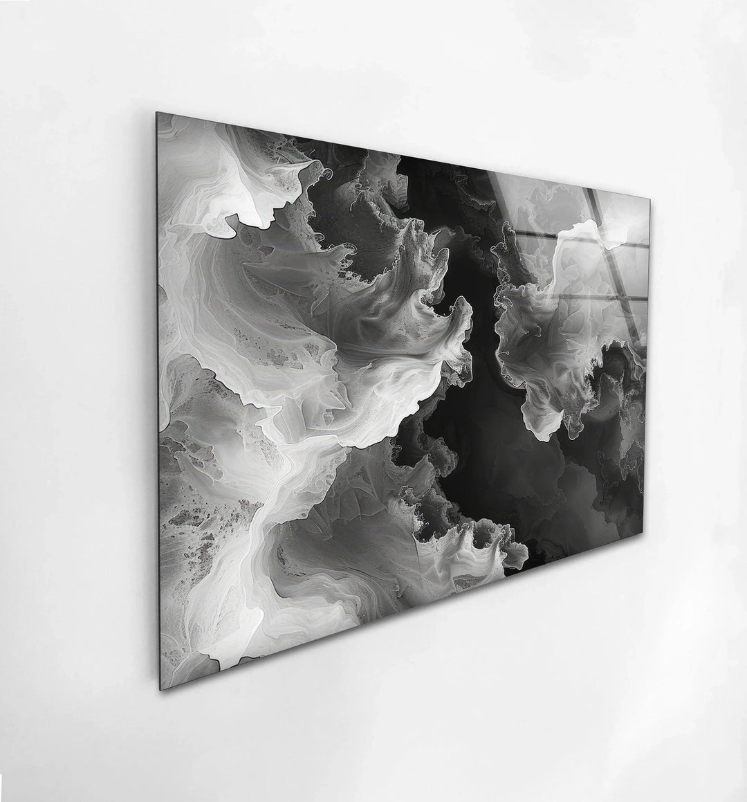 Black and white abstract design printed on glass with cloud-like waves and deep shadowed areas.