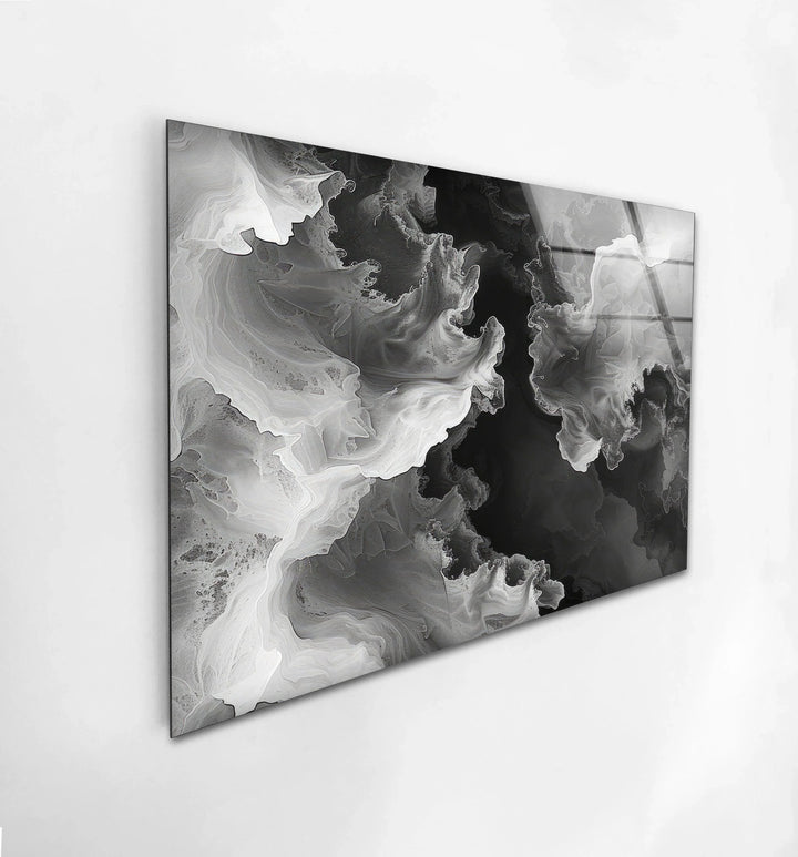 Black and white abstract design printed on glass with cloud-like waves and deep shadowed areas.