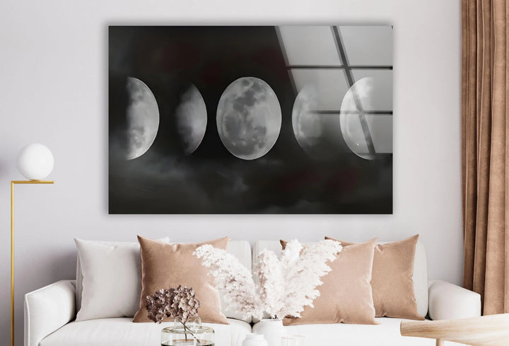 Artistic moon phase display on glass with soft grayscale clouds enhancing the celestial theme.