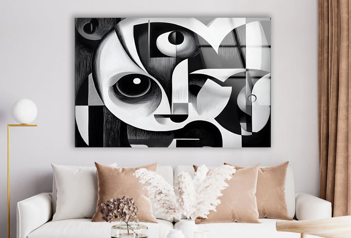 Grayscale cubist design on glass with layered shapes forming a stylized human face.