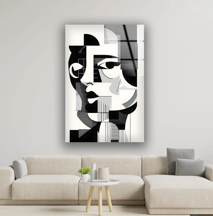 Black and white glass wall art featuring a geometric abstract portrait of a woman with sharp angular shapes.