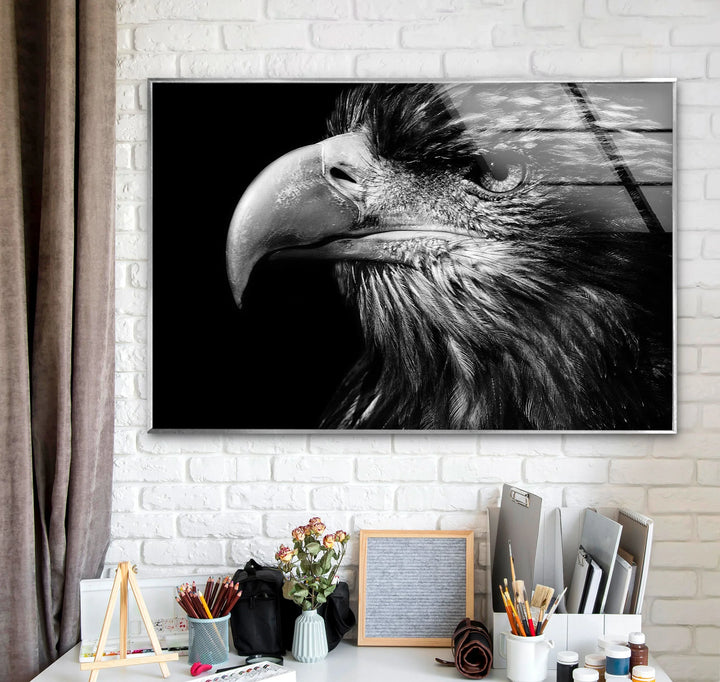 Powerful eagle head captured in dramatic lighting as a bold glass wall art piece.