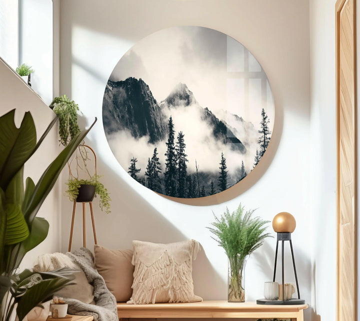 Peaceful fog-covered mountains and forest silhouettes displayed on glass landscape art.