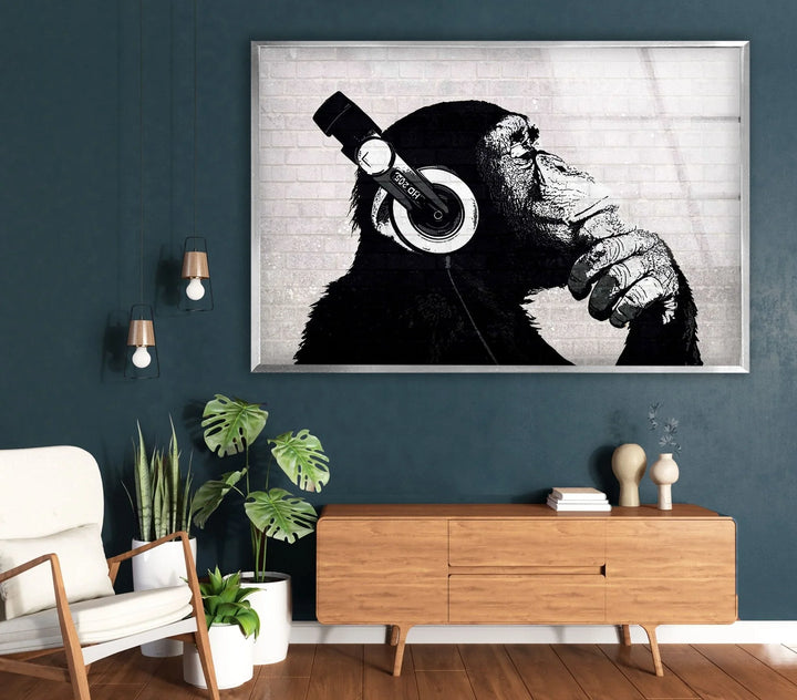 Banksy Dj Monkey Artistic black and white chimp illustration on glass with a textured brick backdrop.