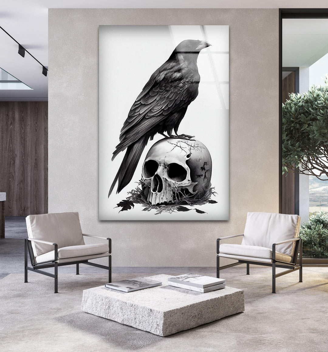 Black and white art on glass showcasing a raven resting on a weathered skull with textured shadows.