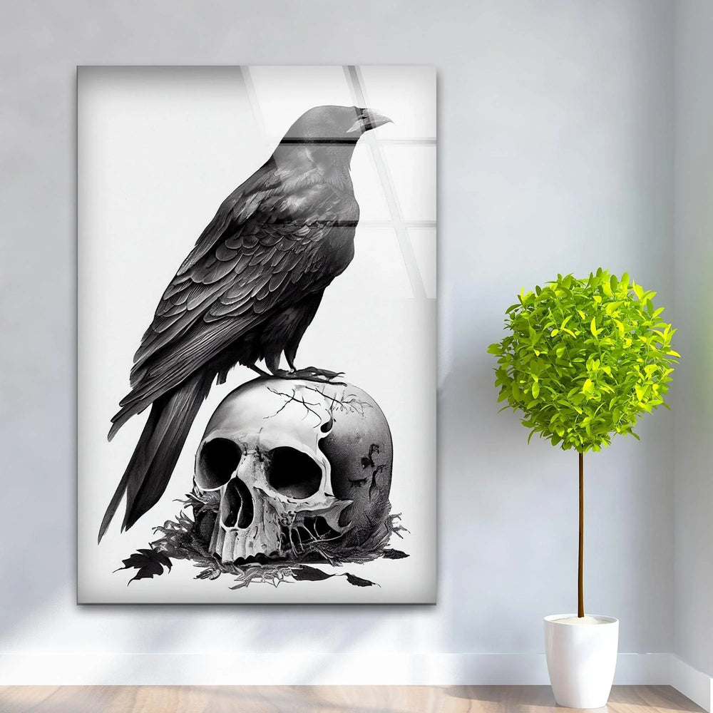 Monochrome glass artwork showing a realistic raven standing over an aged skull surrounded by fallen leaves.