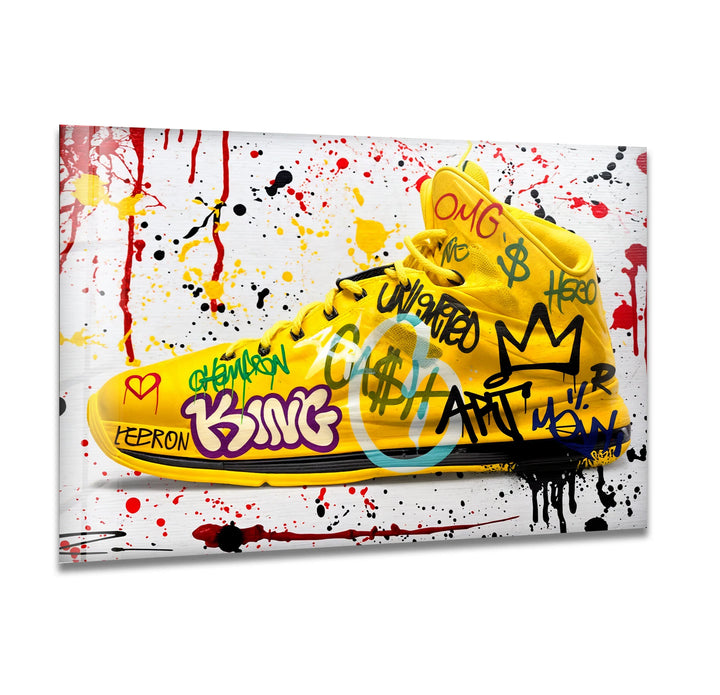 Lebron Shoes Glass wall art featuring a bright yellow basketball sneaker covered in colorful graffiti designs.