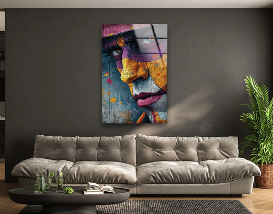 The plush velvet sofa creates the softest element in this living room setting featuring graffiti woman portrait glass wall art.