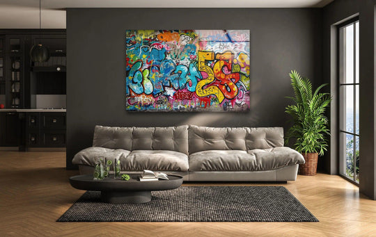 A stylish contemporary living room features a striking street graffiti glass art piece as the focal background.