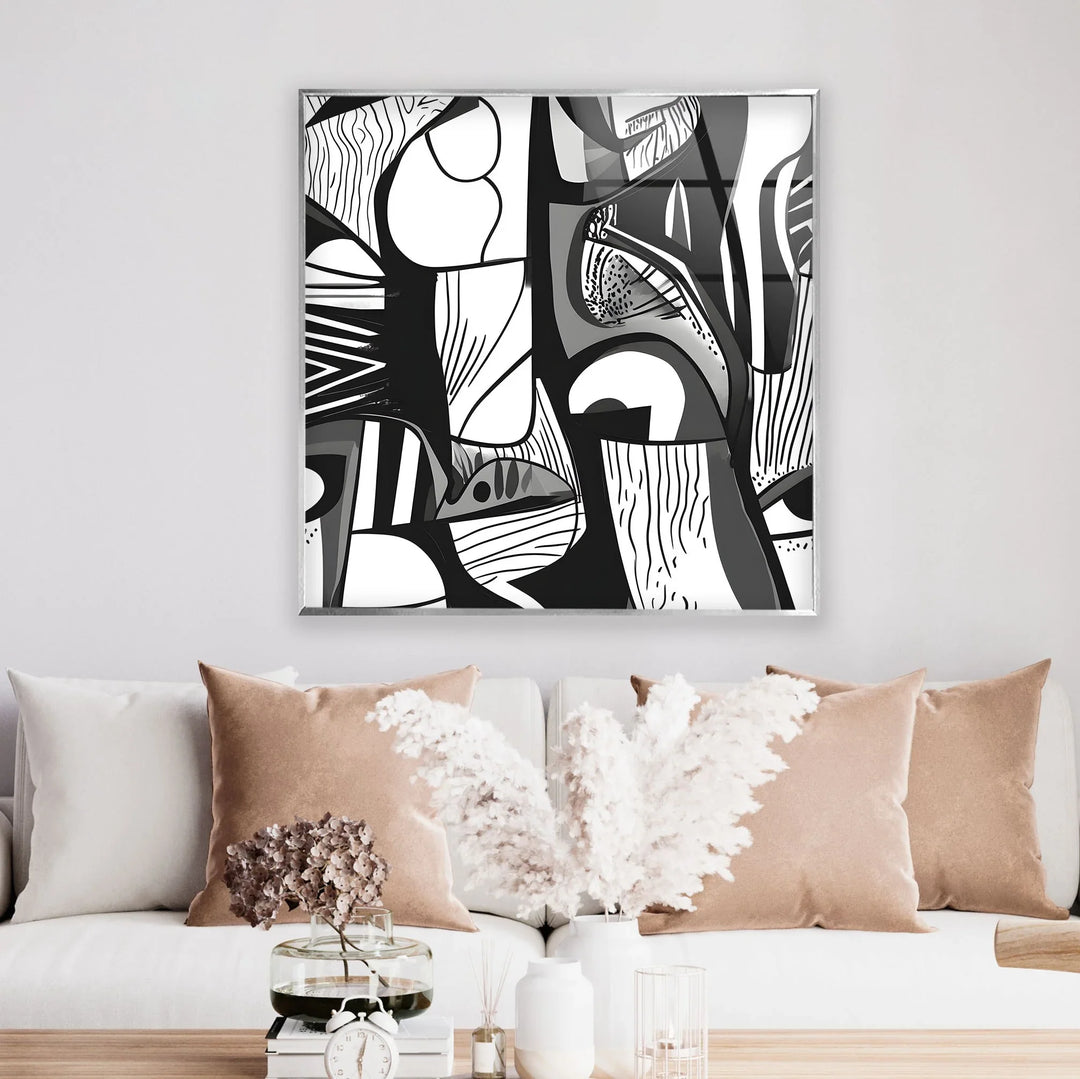 Abstract black and white glass artwork combining layered shapes, linear textures, and expressive eyes.