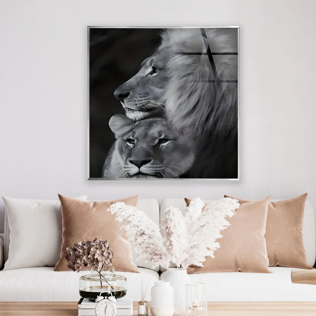 Artistic glass wall art of a noble lion standing over a peaceful lioness in monochrome tones.