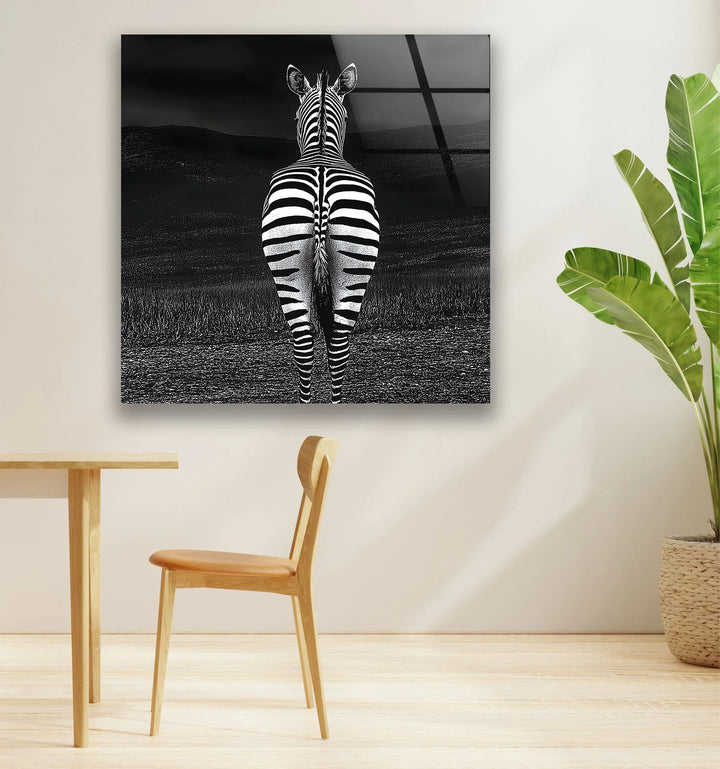Grayscale wildlife artwork on tempered glass with a rear-view zebra and textured landscape.