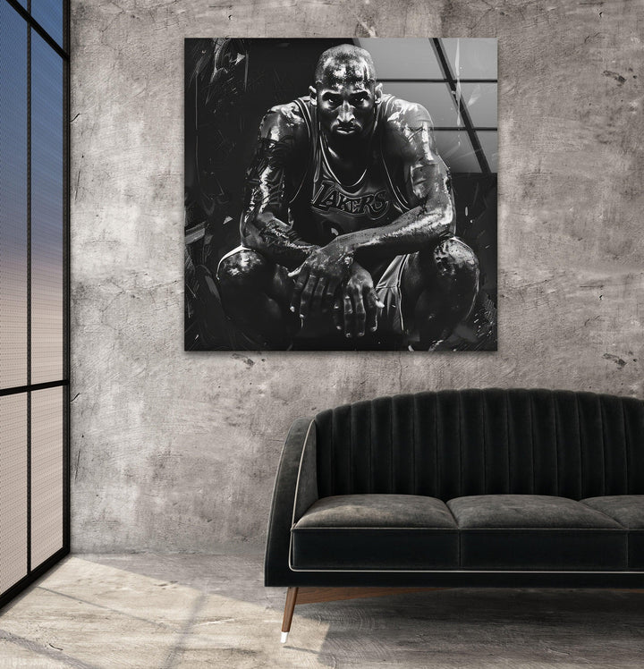 Dramatic monochrome athlete artwork on glass showing a basketball figure crouched with expressive shading.