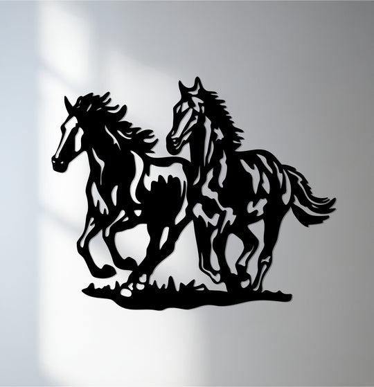 Strong color contrast emphasizes the black silhouette of galloping horses in this striking metal art for wall.
