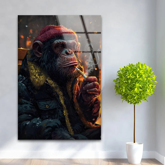 Bold contrast highlights a chimpanzee in a red beanie, smoking, on striking glass wall art decor.