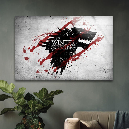 Ominous mood radiates from this minimalist glass wall art featuring the Winter Wolf emblem, a decorative wall art piece with a striking red splash design.