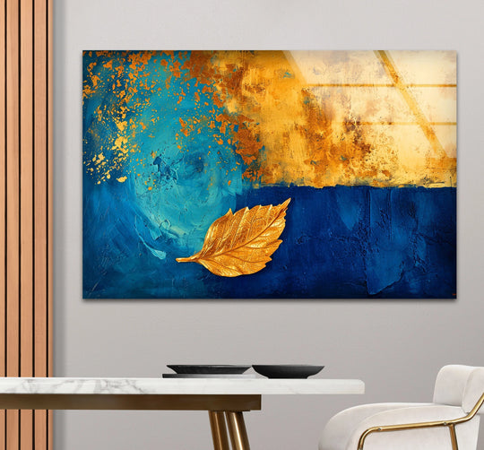 Striking contrast between deep navy and luminous gold textures in this abstract glass wall artwork featuring a golden leaf.