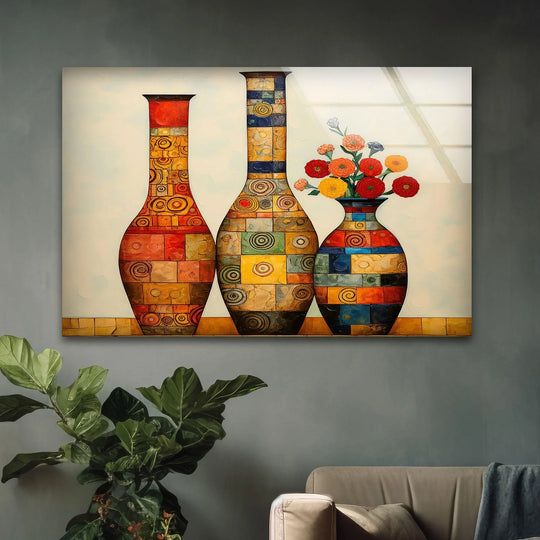 A vibrant, abstract glass wall art piece featuring three boldly patterned vases with eye-catching circular and rectangular motifs.
