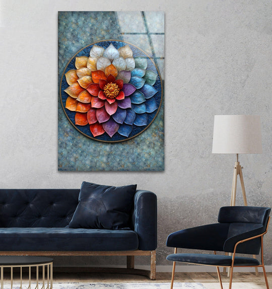 A colorful floral mandala made of art from glass hangs above a plush navy sofa.