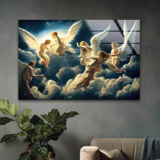 Lush green leaves of a potted plant complement the Heaven and Angels glass wall art decor, set behind a neutral-toned couch in the foreground.