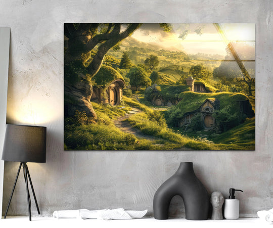 Smooth surface texture showcases a sunlit hillside cottage village in this fantasy tempered glass wall art, reflecting light and adding depth to the detailed landscape.